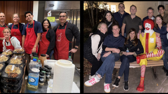 Volunteers from a corporate group gather at Ronald McDonald House in Northern Virginia after preparing a home-cooked meal for families. The first photo shows smiling volunteers in red aprons standing behind trays of freshly prepared food; the second shows the same group outside the House, sitting with the Ronald McDonald bench statue, sharing smiles after serving families in need.